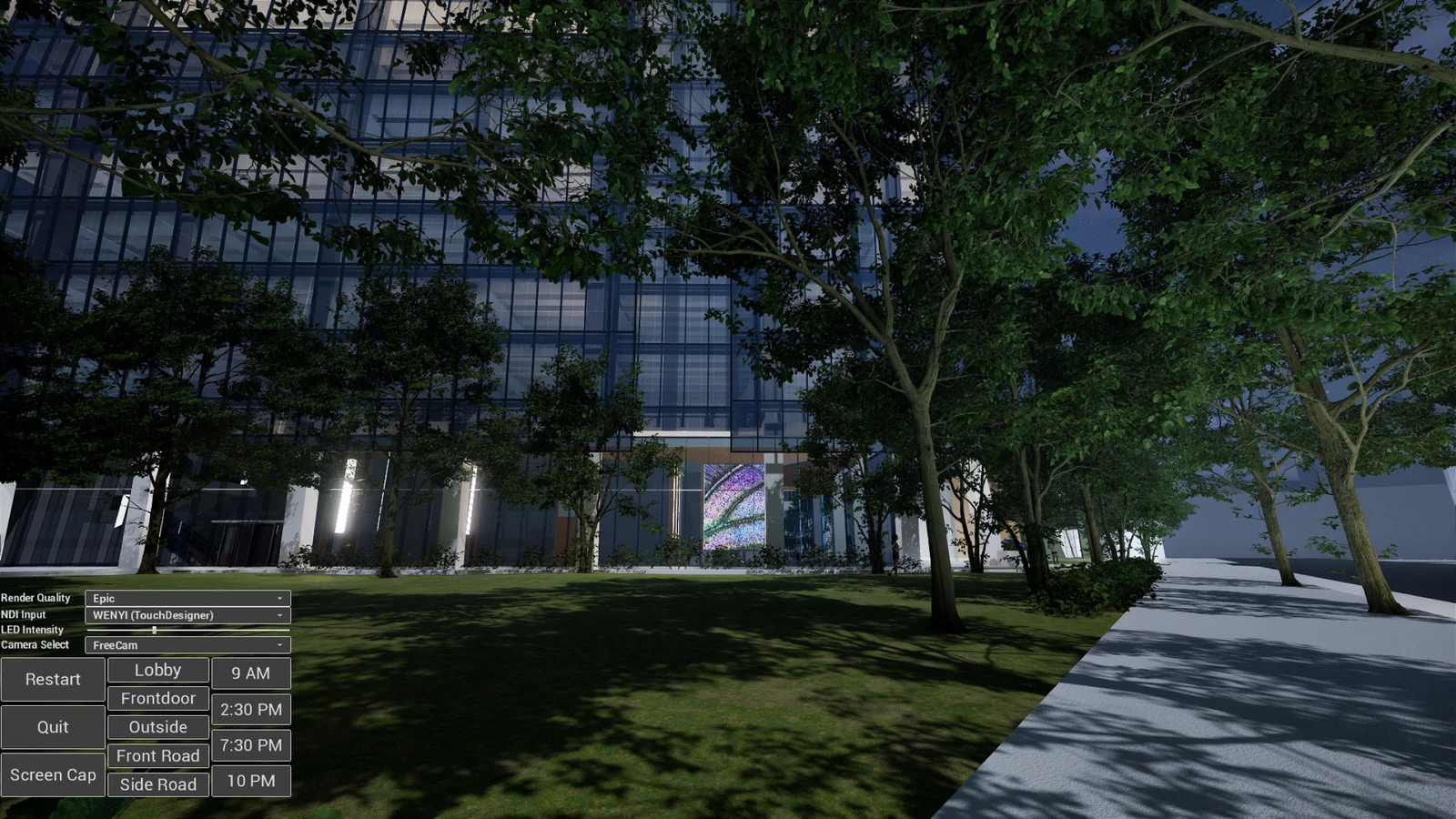 Evening exterior view of the same building with the LED wall lit